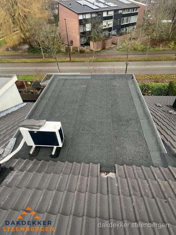 Plat dak inspectie met bitumen bedekking naast schuin pannendak in Steenbergen Plat dak inspectie met bitumen bedekking naast schuin pannendak in Steenbergen